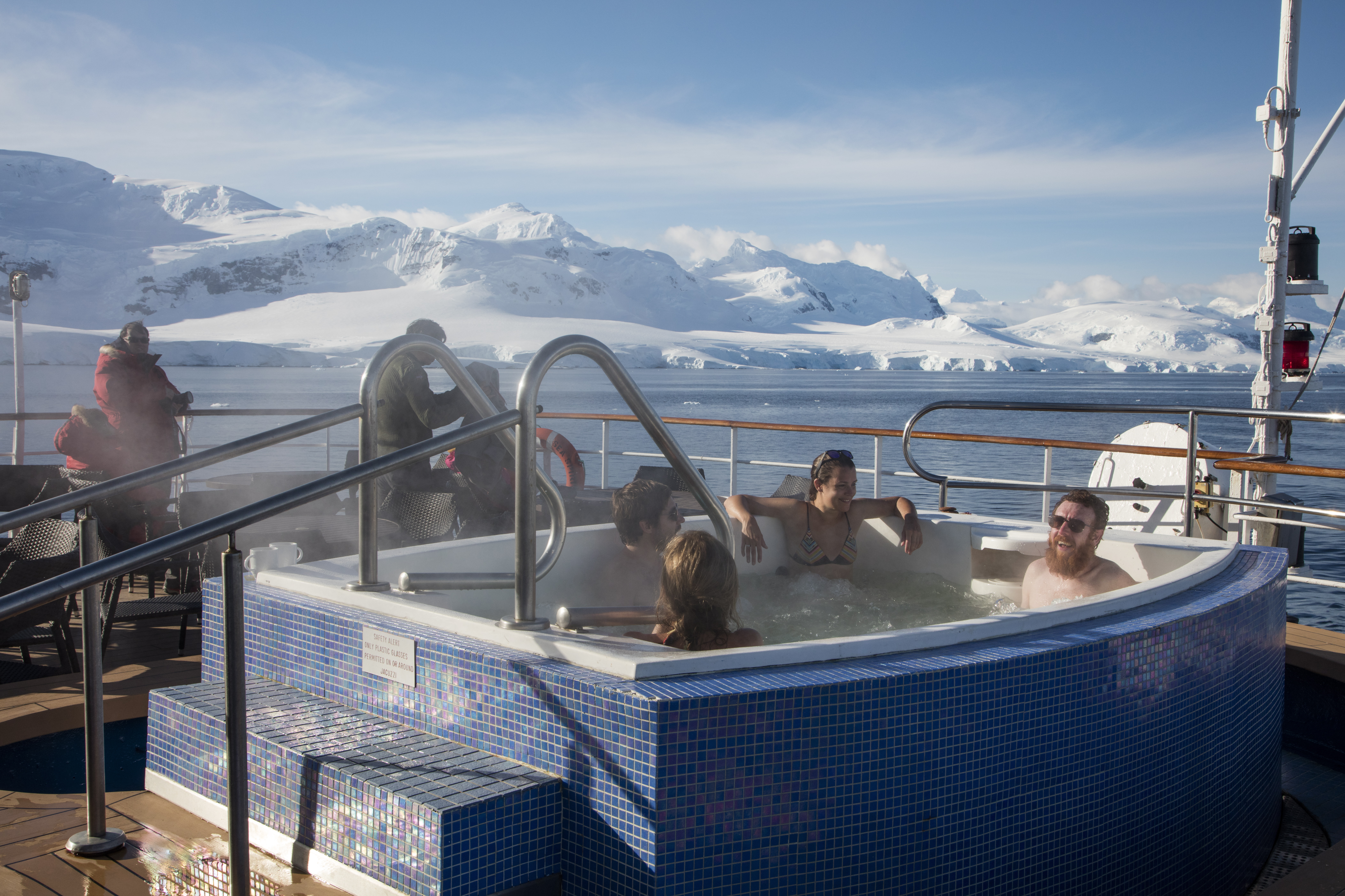 Passengers relax in jacuzzi aboard expedition cruise ship MV Sea Spirit (Poseidon Expeditions), Gerlache Strait, Graham Land, Antarctic Peninsula, Antarctica